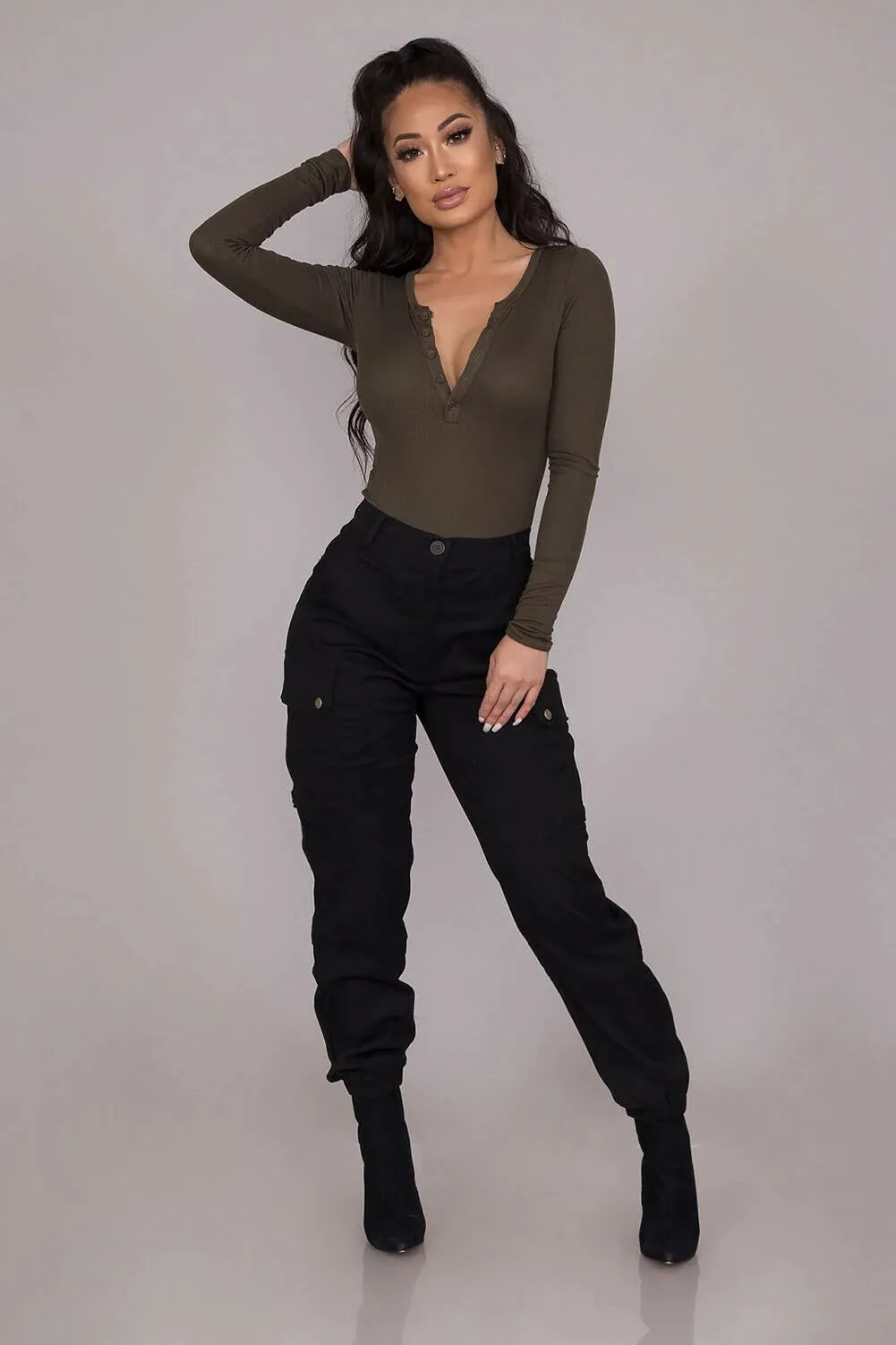 "Upgrade your style with these chic high-waisted black cargo pants featuring button pockets and a gothic twist. These solid color, long trousers are perfect for all sizes. Get yours now!"